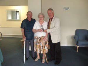 Peter Biggs presents silver cup to residents of Edith Court